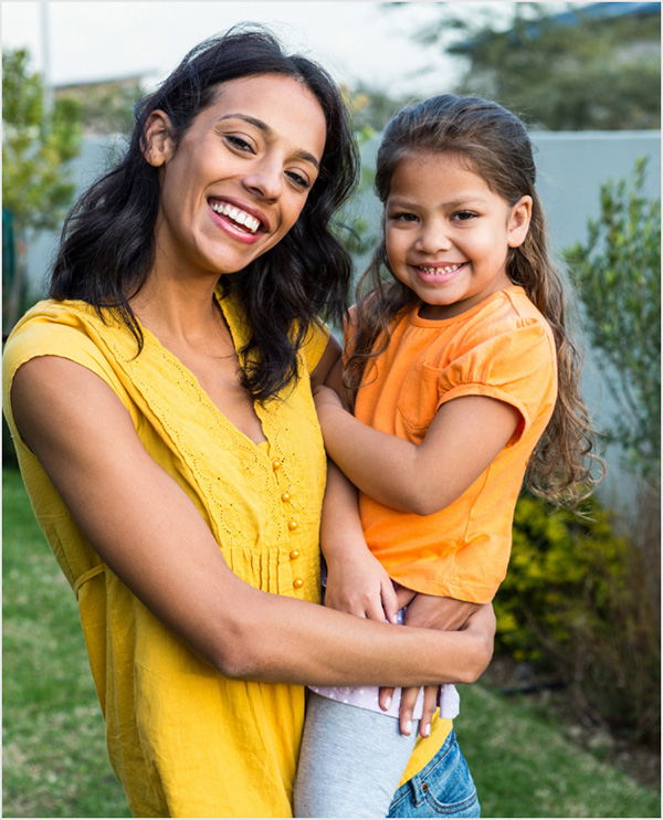 mother_holding_daughter_USDA_productpage Mother holding daughter in backyard